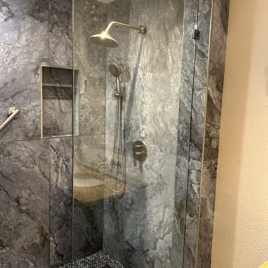 A bathroom with a walk in shower