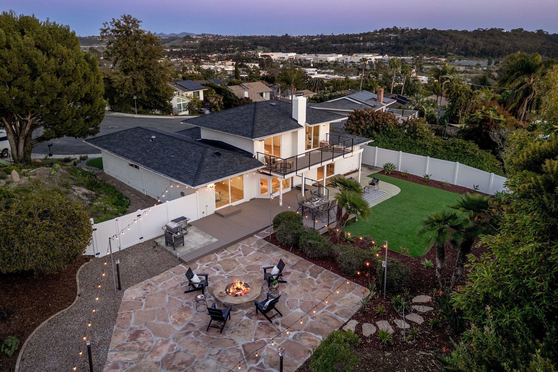 An aerial view of a flipped house in Oceanside, CA with a fire pit in the backyard.