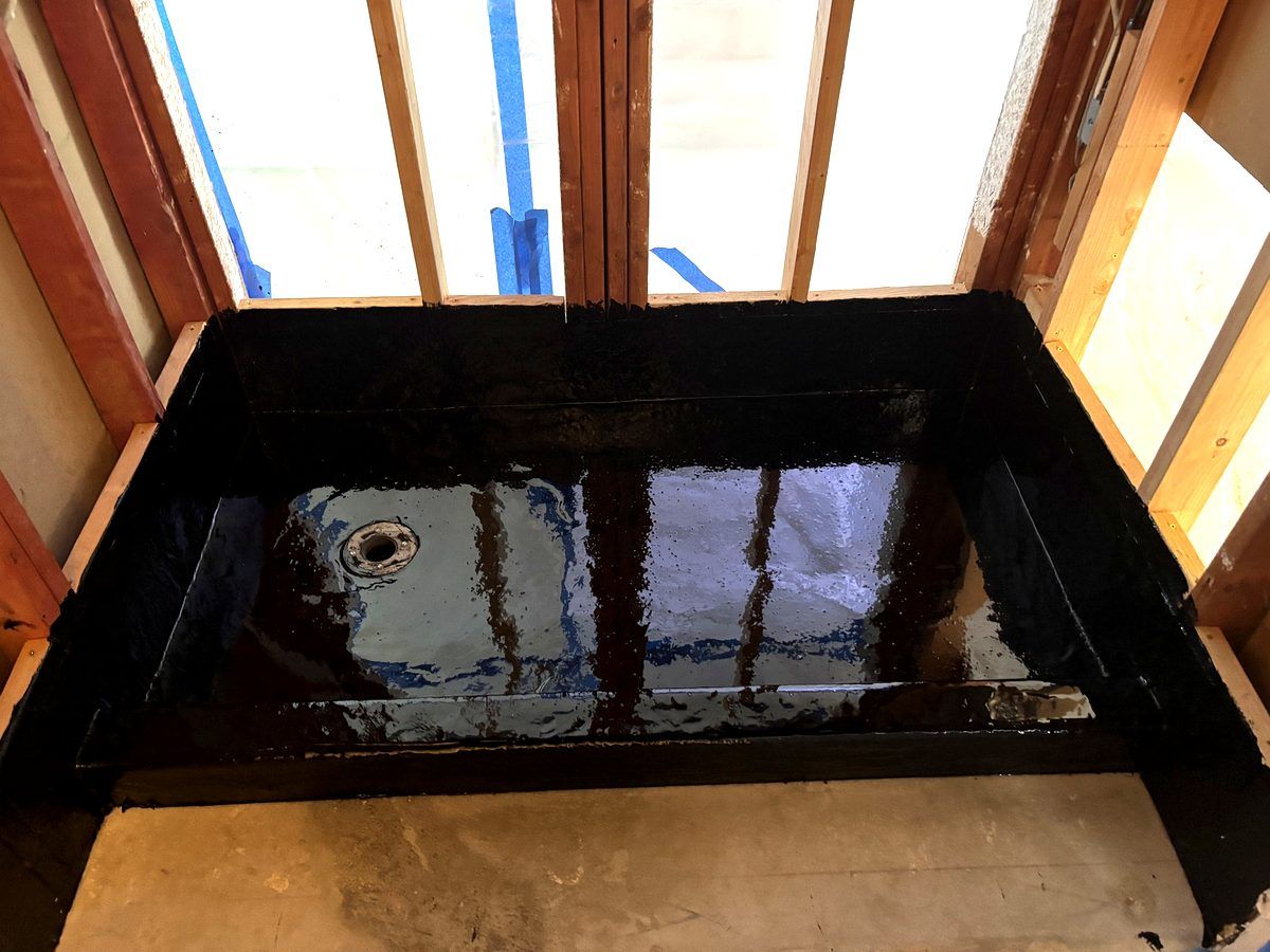 Hot mop shower pan waterproofing photographed as part of Center Home Improvement's process