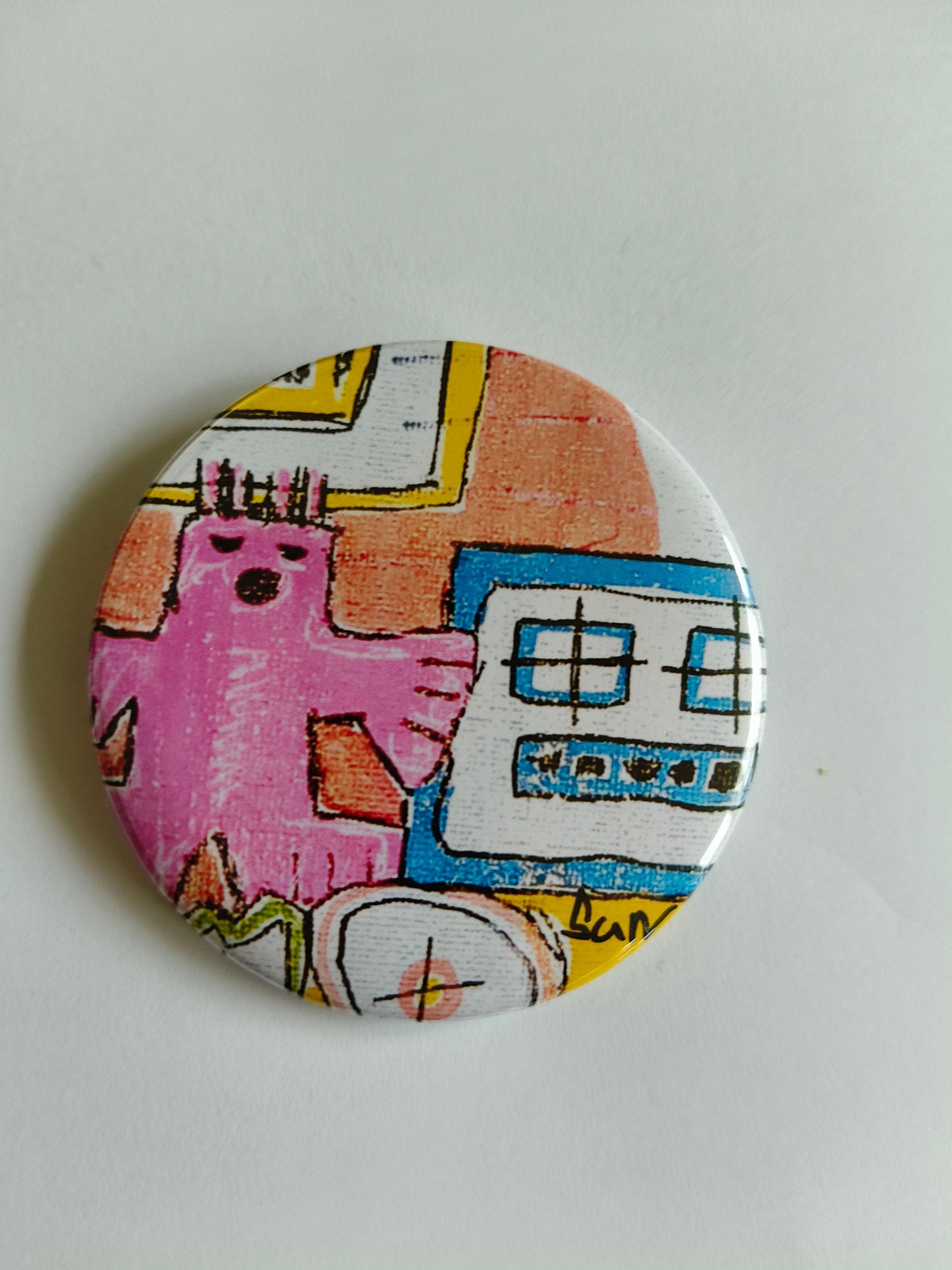 Een ronde knop met een kleurrijke, handgetekende illustratie van een roze vogel