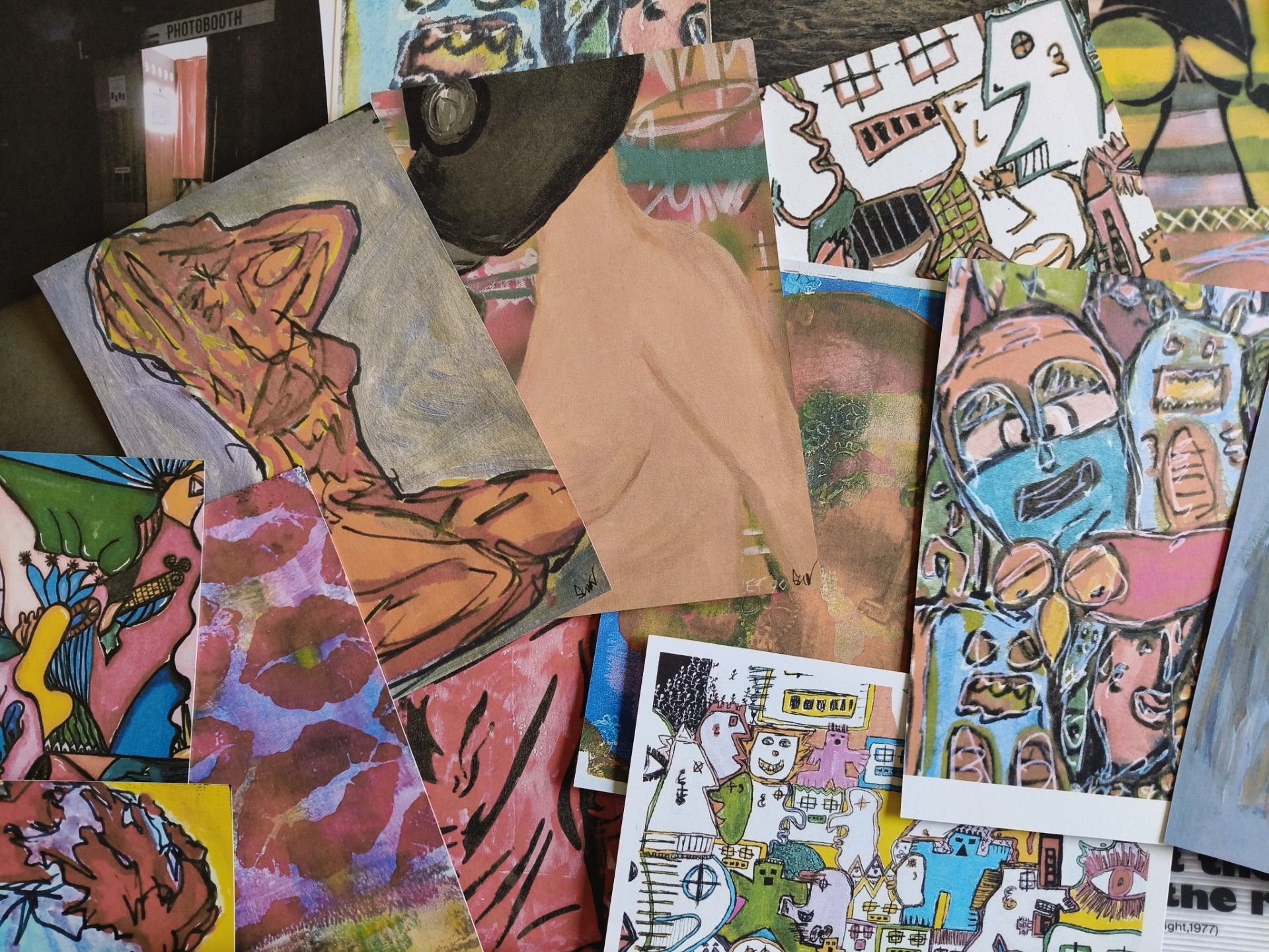 Een verzameling overlappende artistieke postkaarten, waaronder abstracte figuren, kleurrijke schetsen en patronen.
