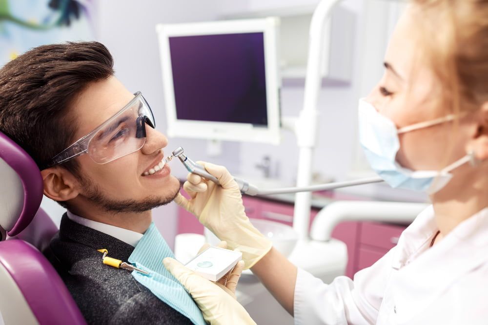 Female Dentist With Nervous Patient — Dental Services in Berserker, QLD