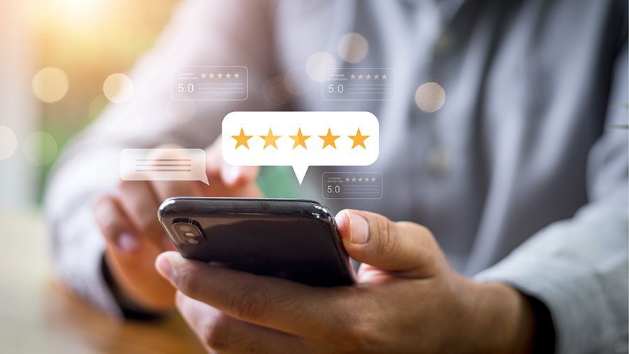Person using a smartphone with a five-star rating graphic overlay in the background