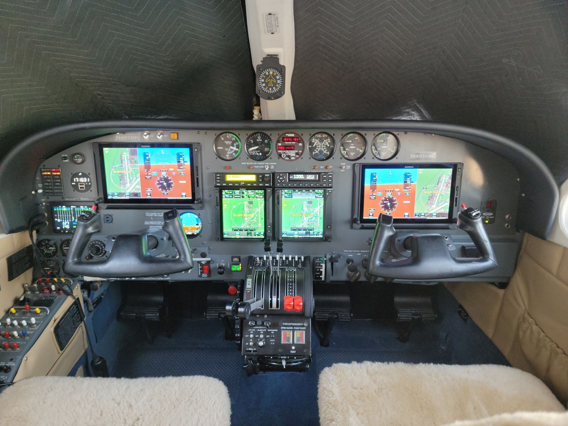 Airplane cockpit with two yokes, colorful flight displays, and instrument panels