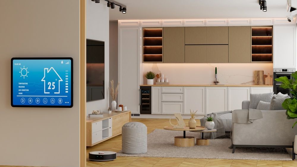 Modern living room with wall-mounted smart thermostat display and open kitchen in the background