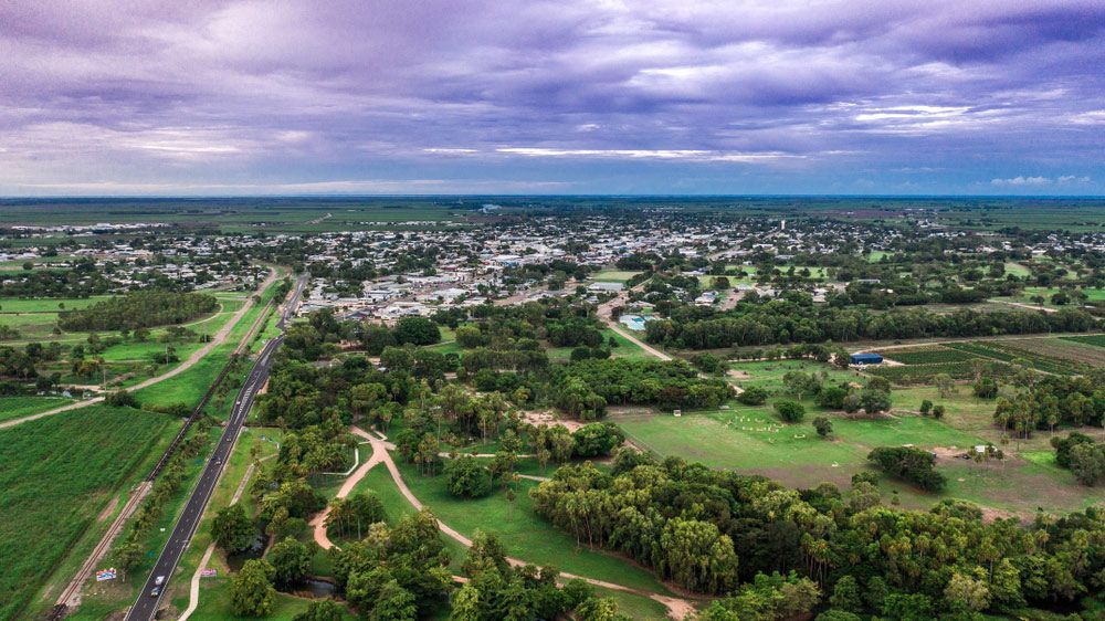 An Aerial View of A Small Town Surrounded by Trees and Fields — Get Stumped Stumping & Maintenance In Ayr, QLD