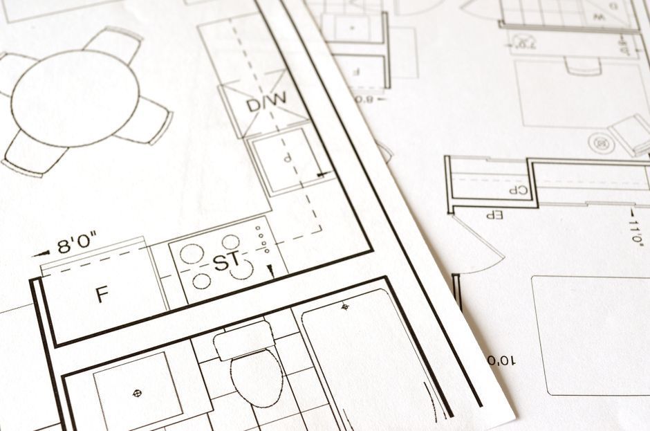 House plans on a table, planning a custom home build