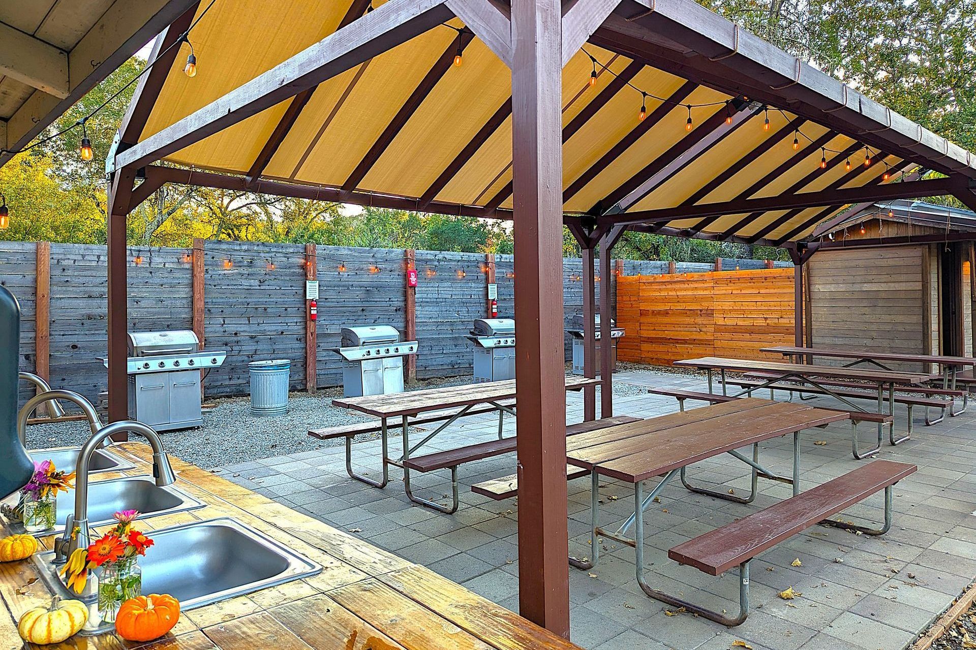 2 BBQ grills next to outdoor kitchen