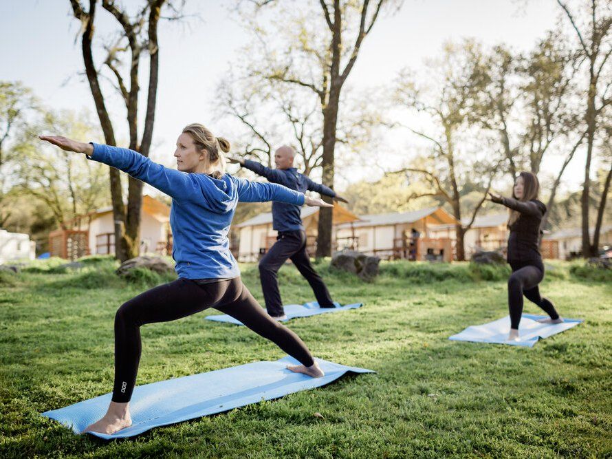 3 people doing outdoor yoga