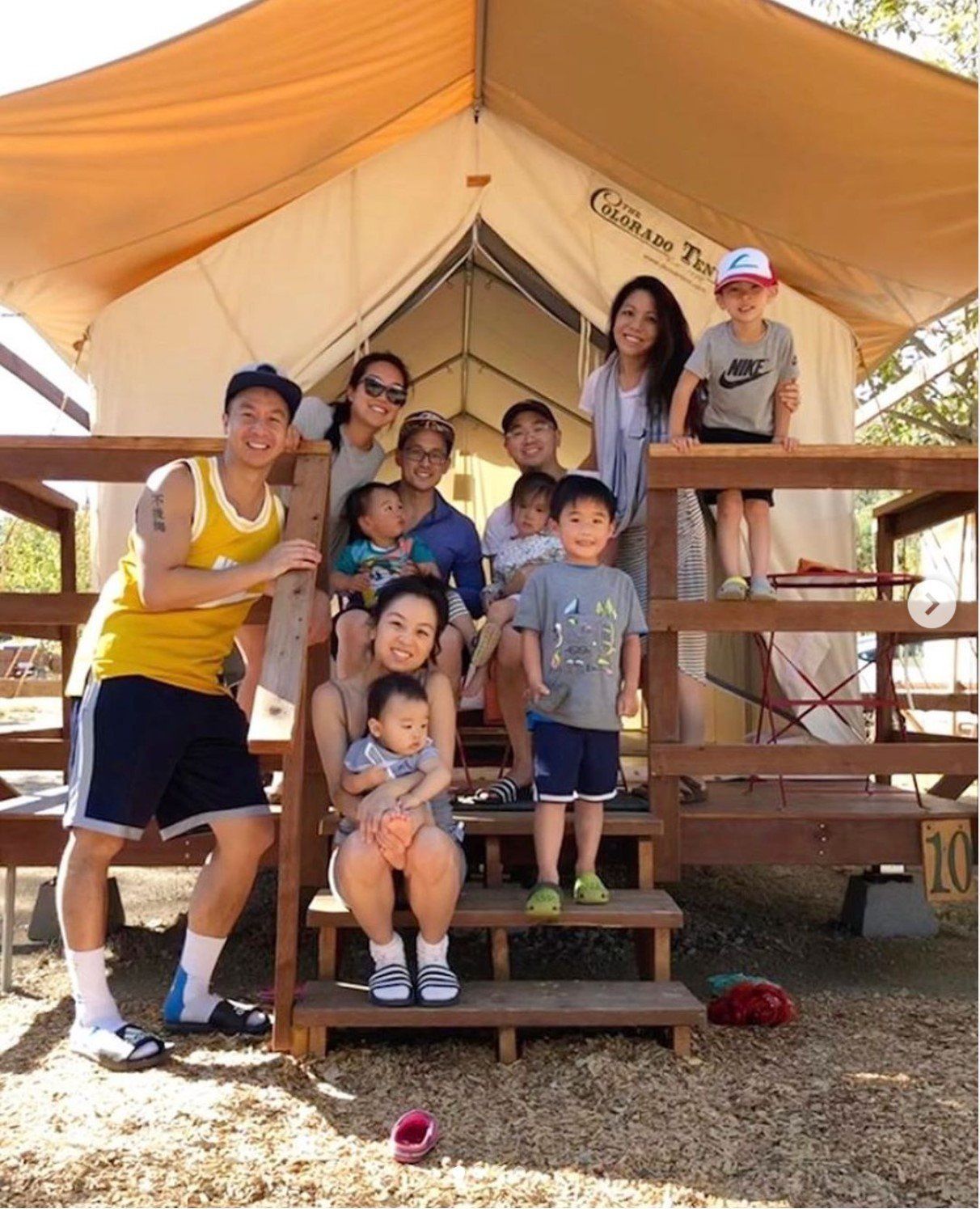 A group of people posing for a picture in front of a tent