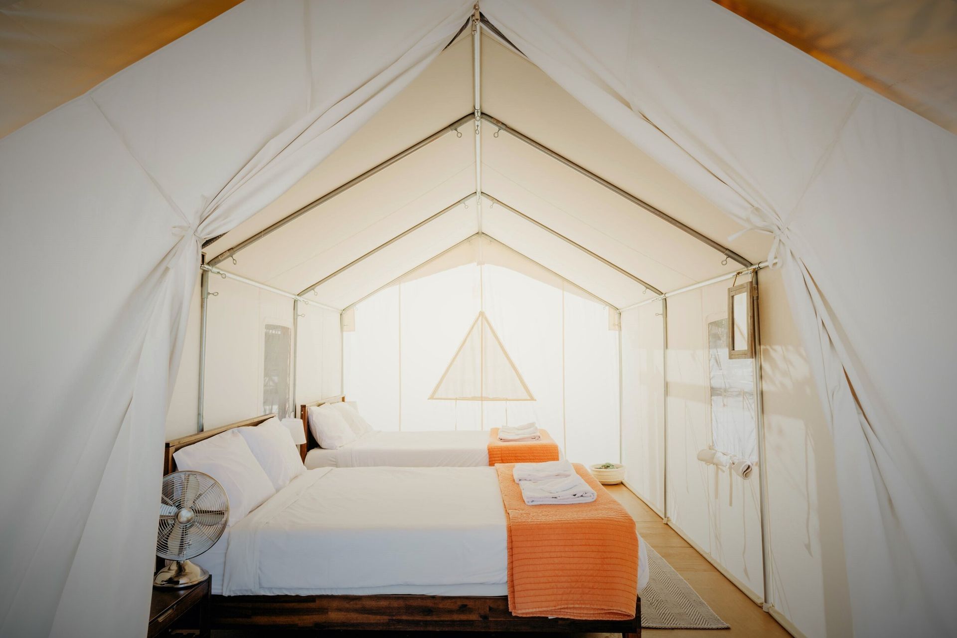 A tent with two beds inside of it