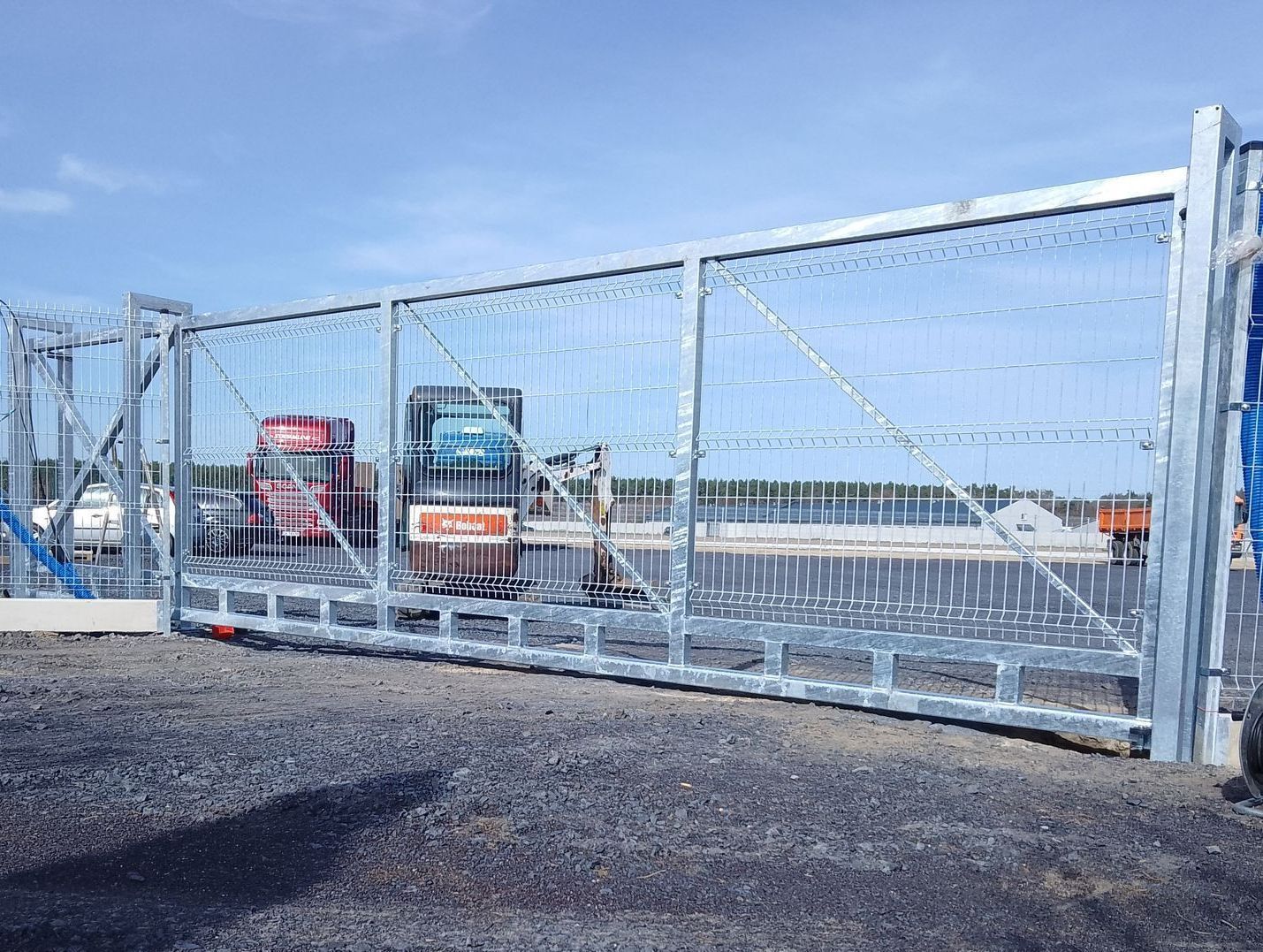 Large galvanized steel sliding gate for industrial facilities and truck entrances, ensuring high security and weather resistance.