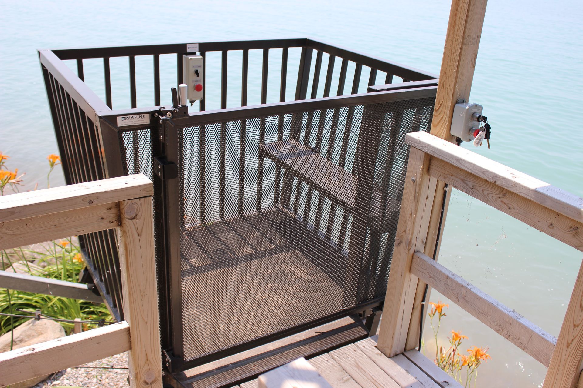 A balcony overlooking a body of water with a metal fence