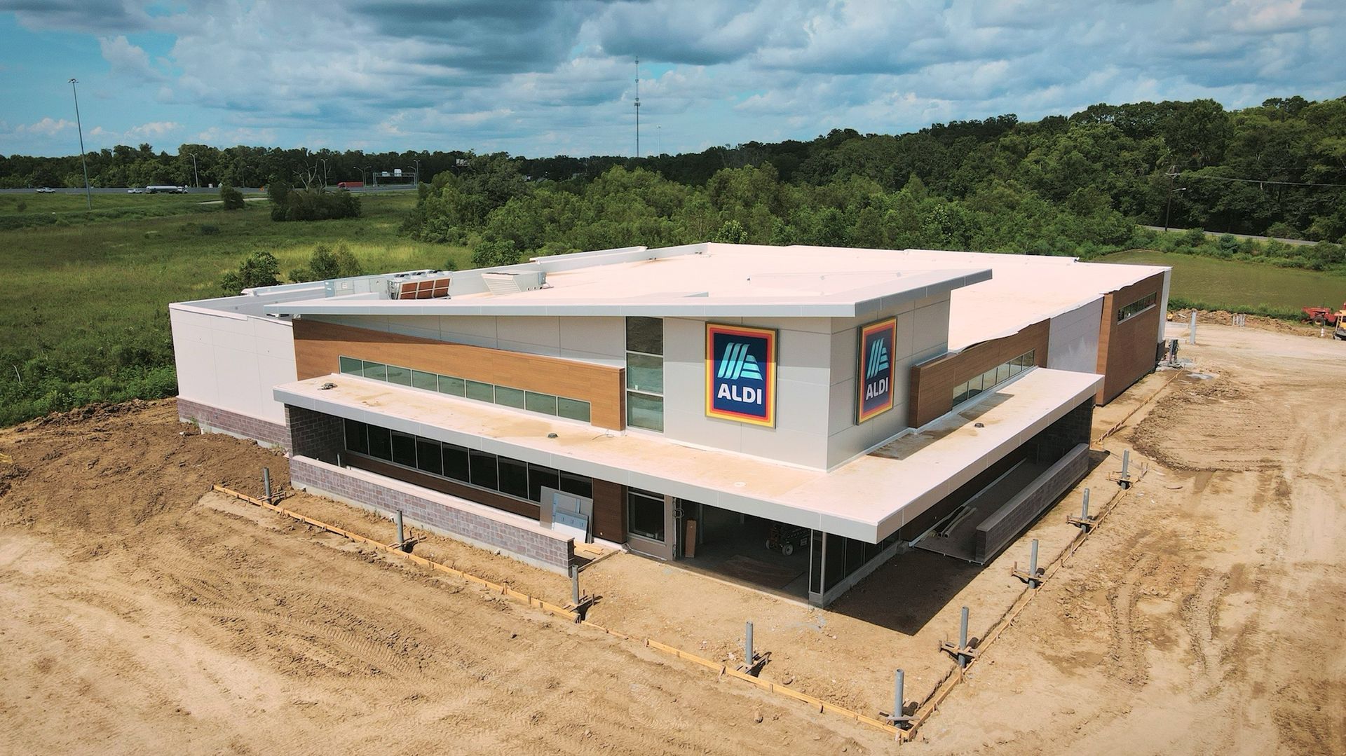 Aerial view of a new Aldi grocery store under construction with an exterior of tan, grey, and brown colors.