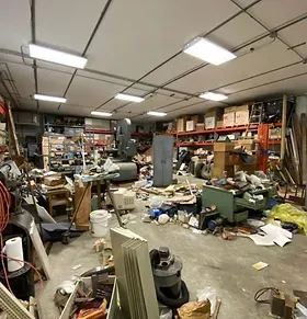A warehouse filled with lots of junk and tools.