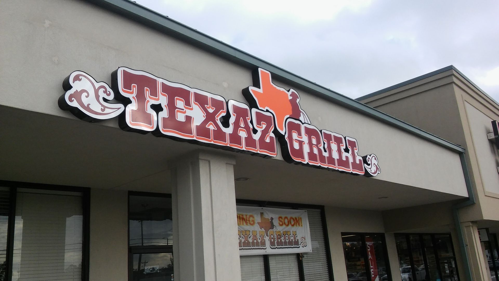 A texas grill restaurant is located in a shopping center
