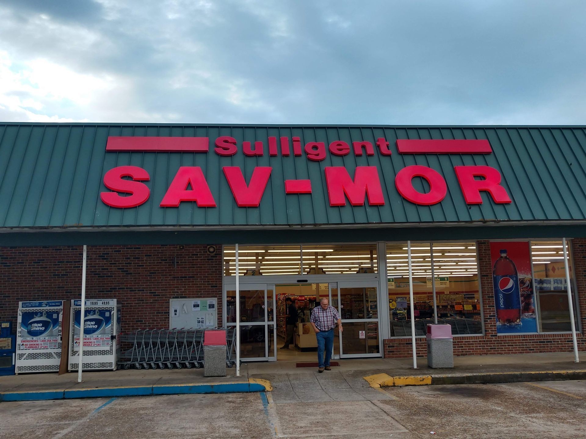 A man is standing in front of a salvation army store