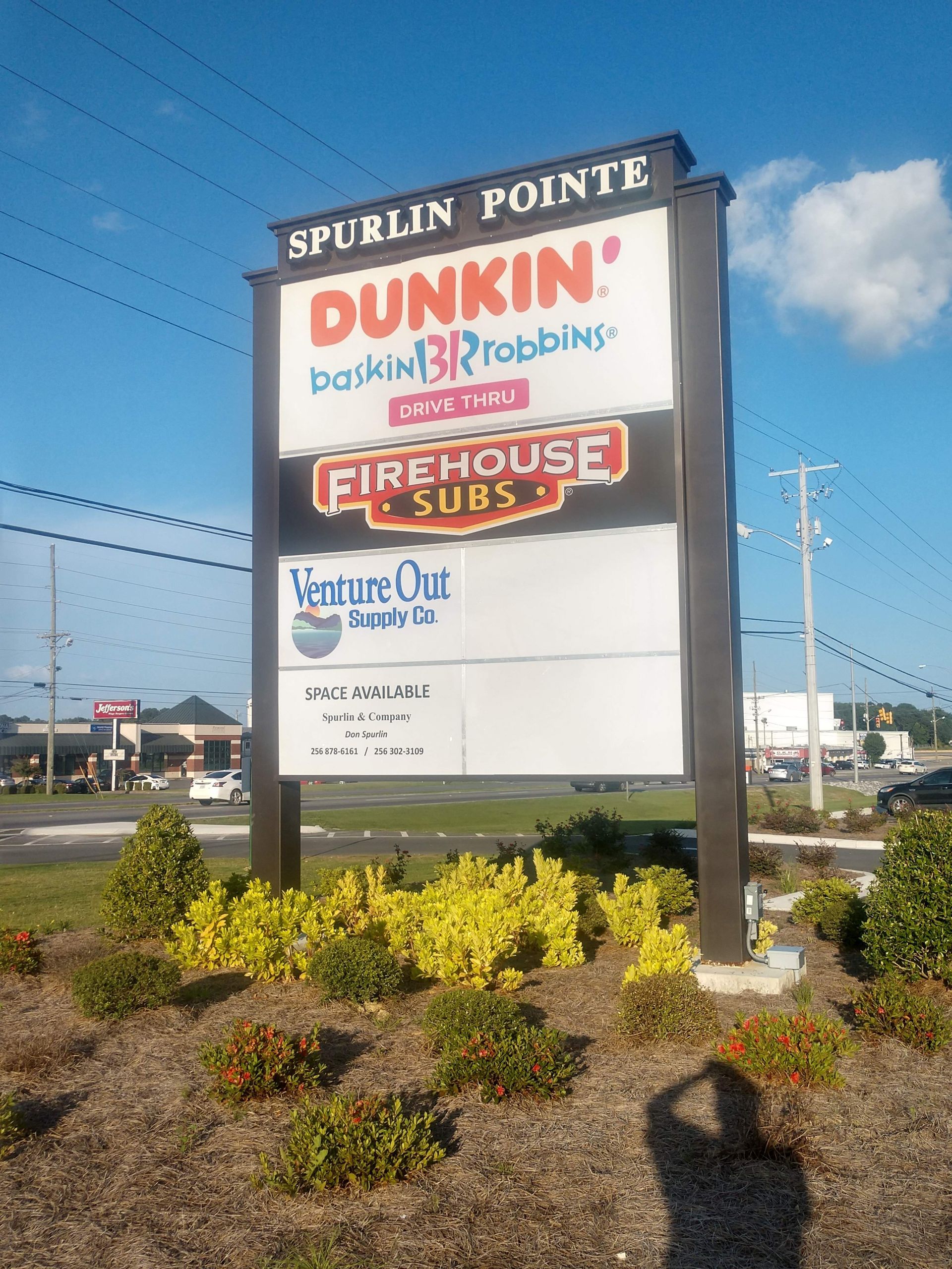 A sign for spurlin pointe dunkin donuts firehouse subs and venture out