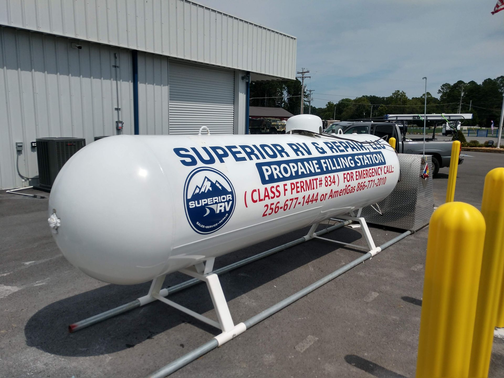 A large white propane tank with superior written on it