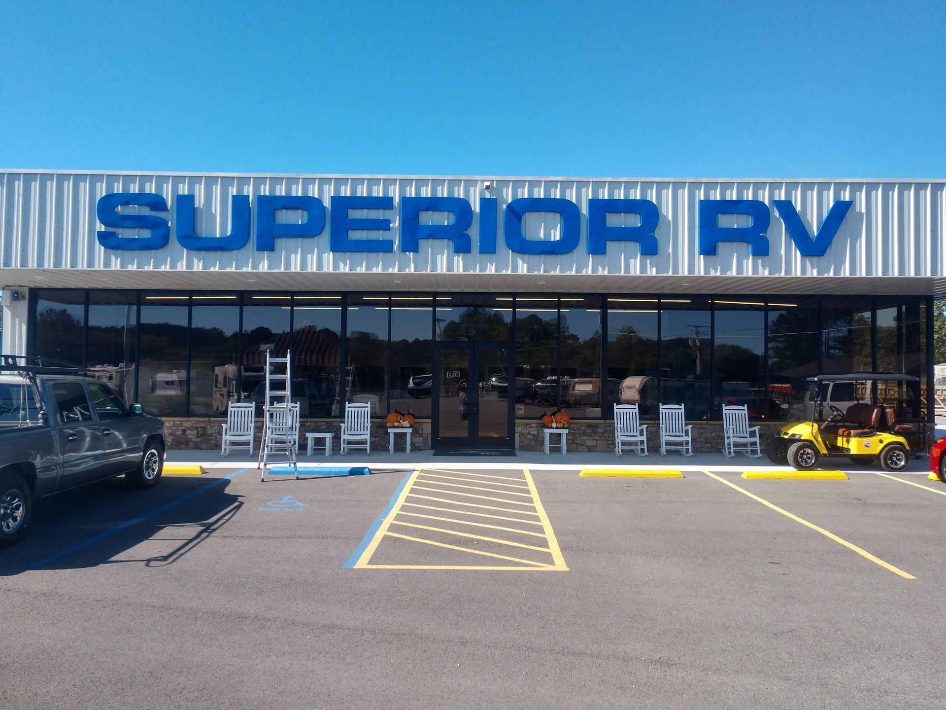 A superior rv store with cars parked in front of it