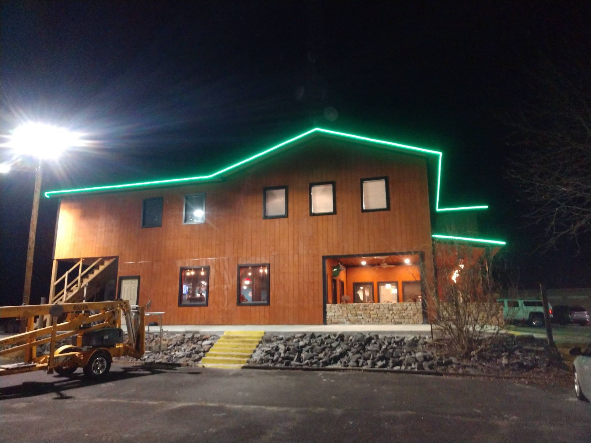 A large building with green lights on the side of it