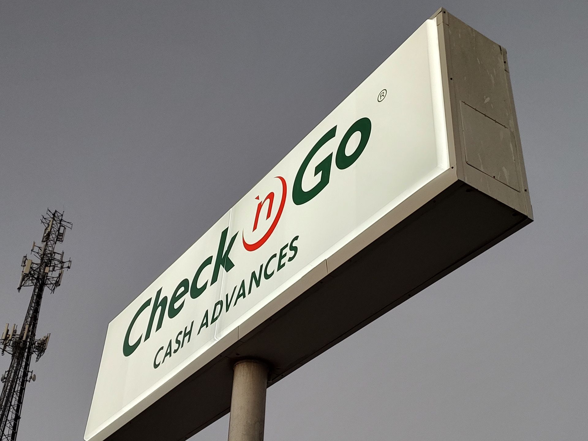 A check n go cash advances sign against a cloudy sky
