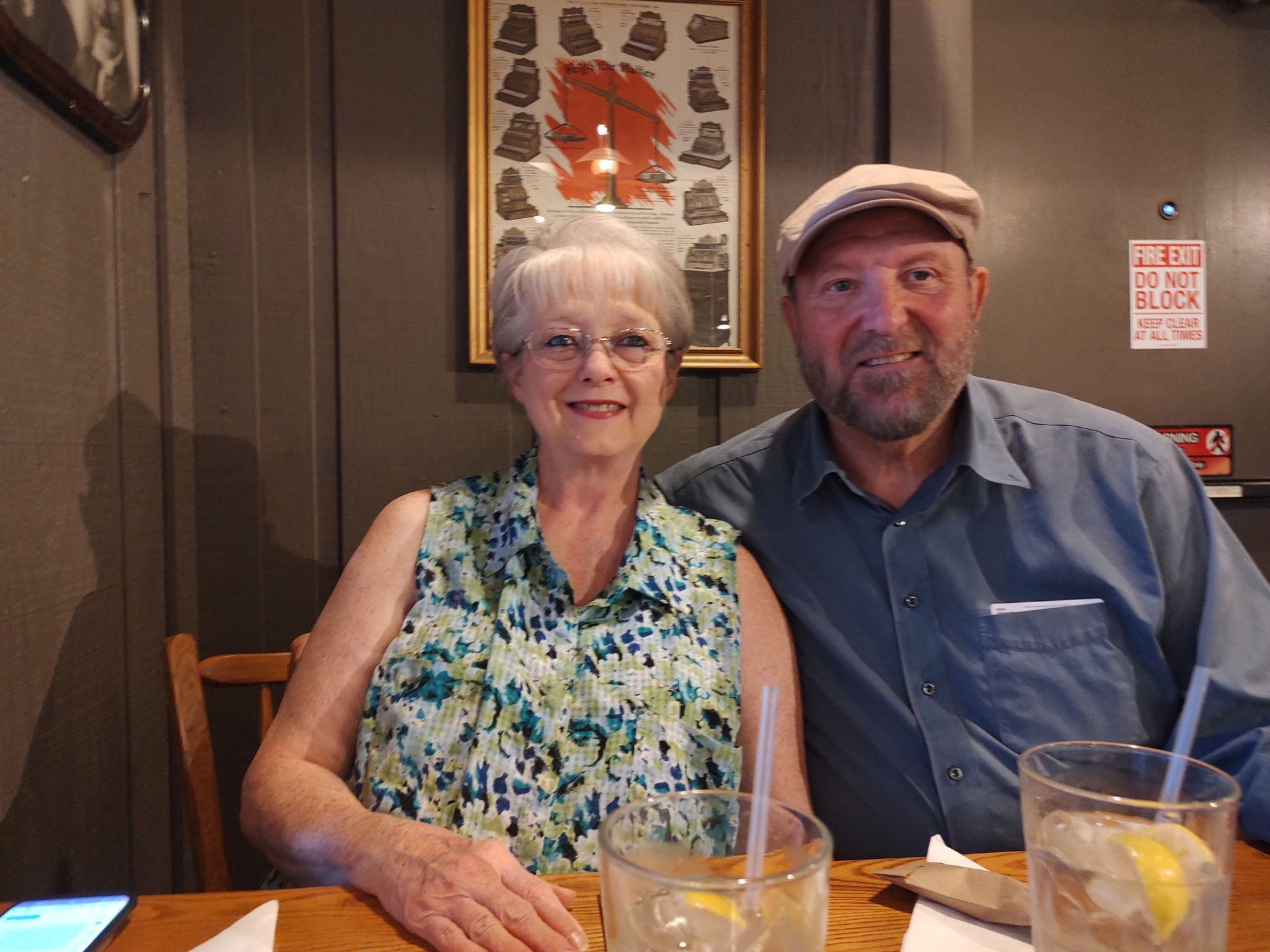 A man and a woman are sitting at a table in a restaurant.