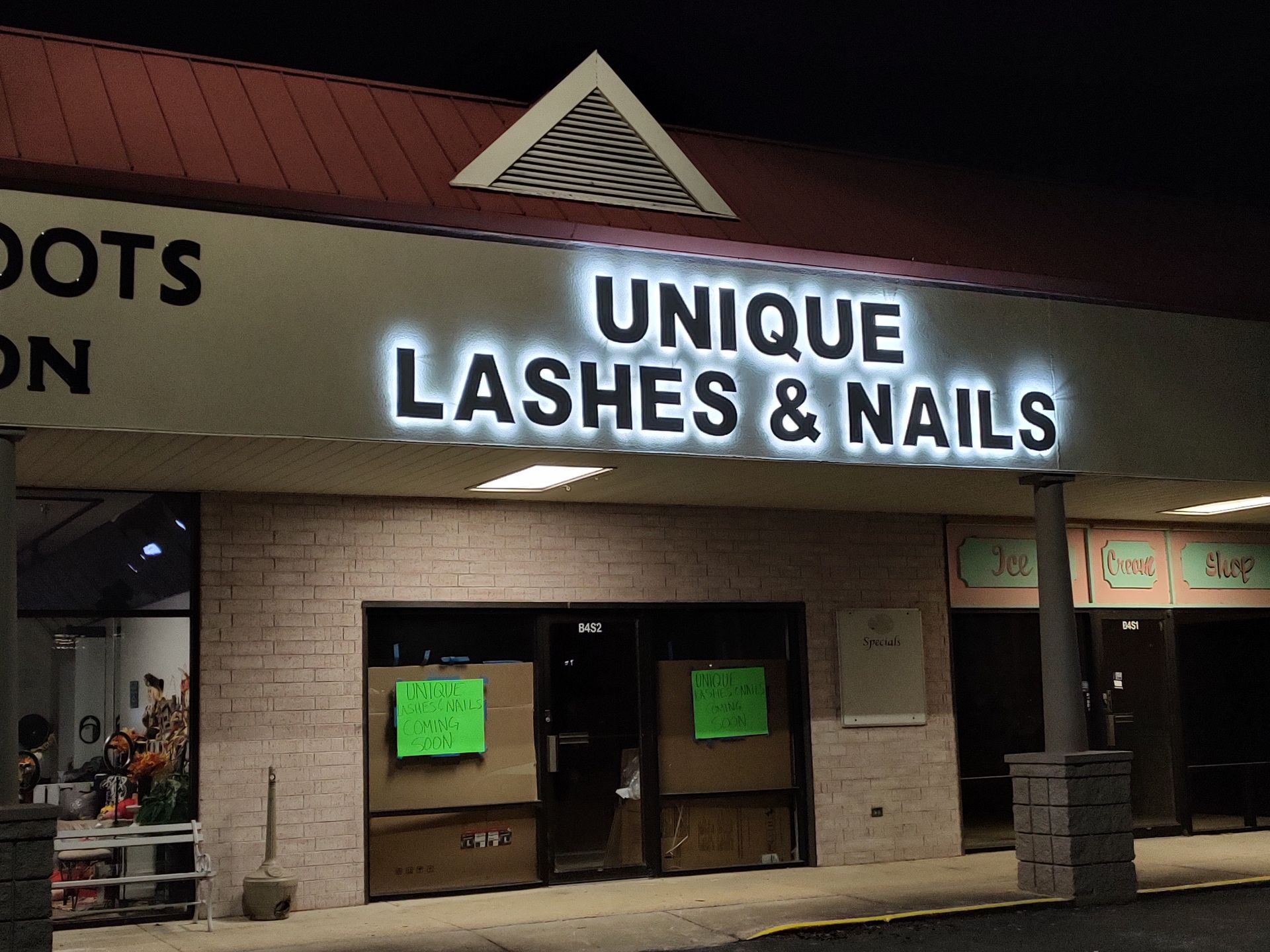 A store front with a sign that says unique lashes & nails