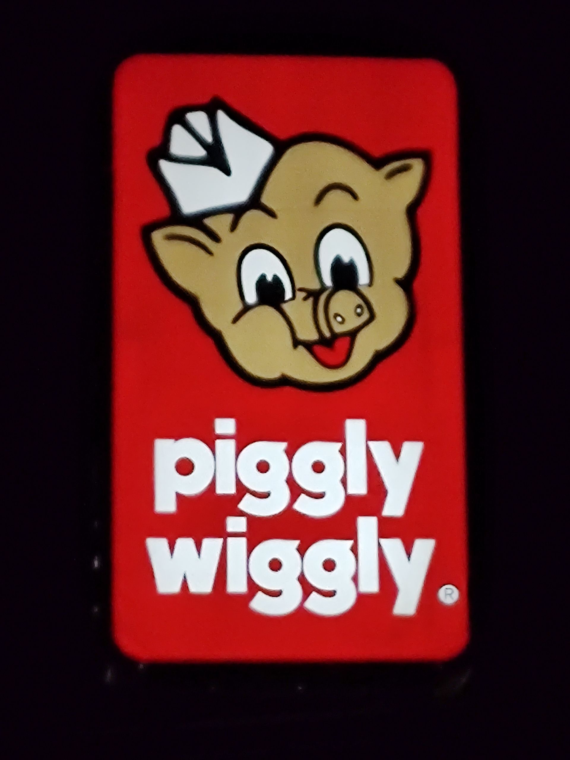 A pigly wiggly sign with a pig on it