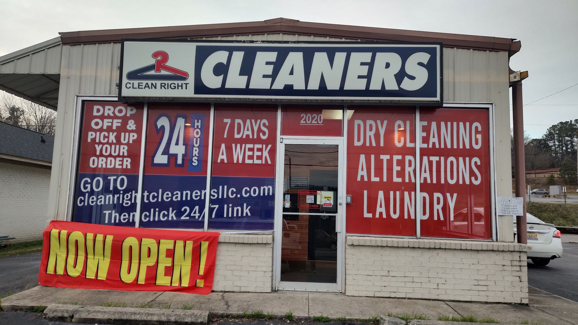 A laundromat with a sign that says cleaners dry cleaning alterations laundry