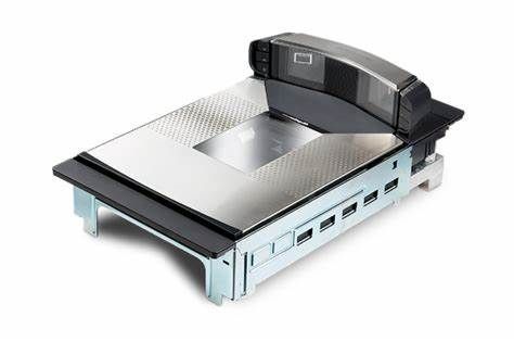 Barcode scanner, black and silver, with a large scan window and several USB ports.