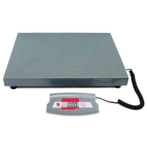 Gray industrial shipping scale with a digital display connected by a black cord.