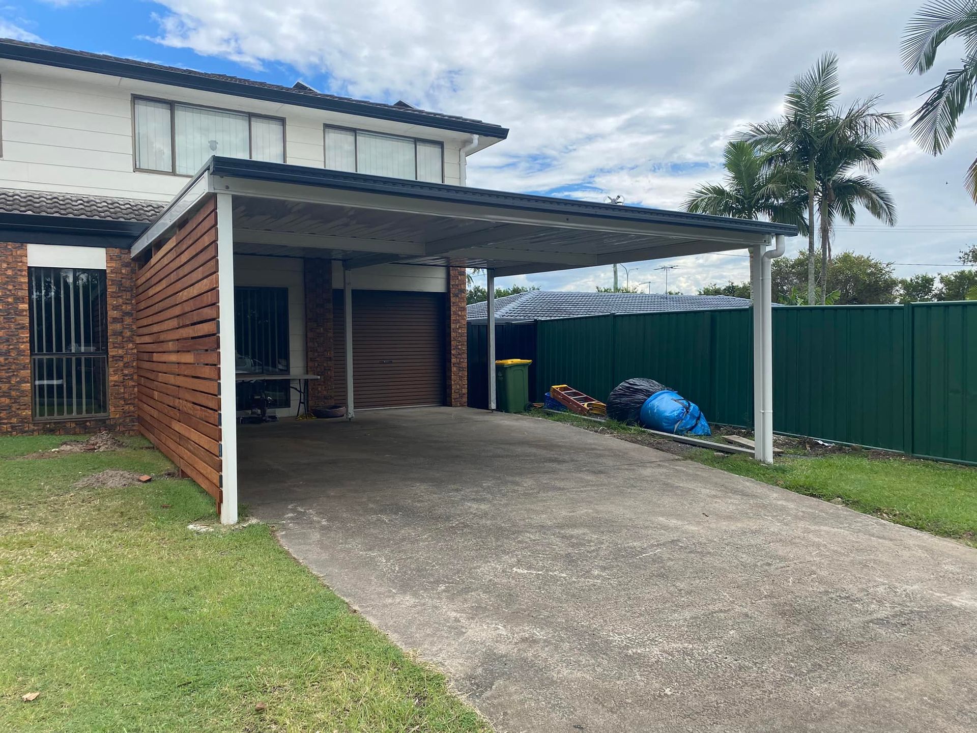 A carport is attached to the side of a house.