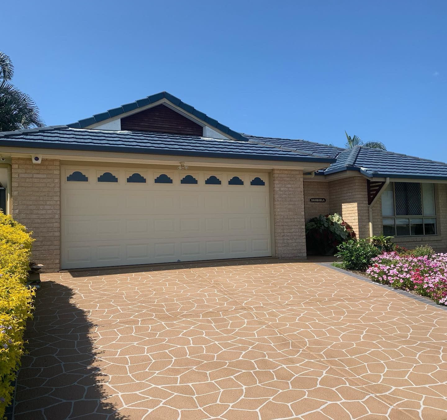 A house with a white garage door and a blue roof