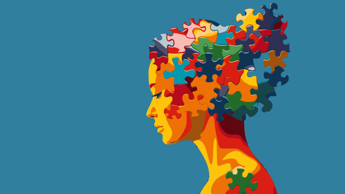 Profile silhouette filled with colorful puzzle pieces on a blue background