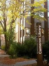 A large building with a sign in front of it that says cameron library.