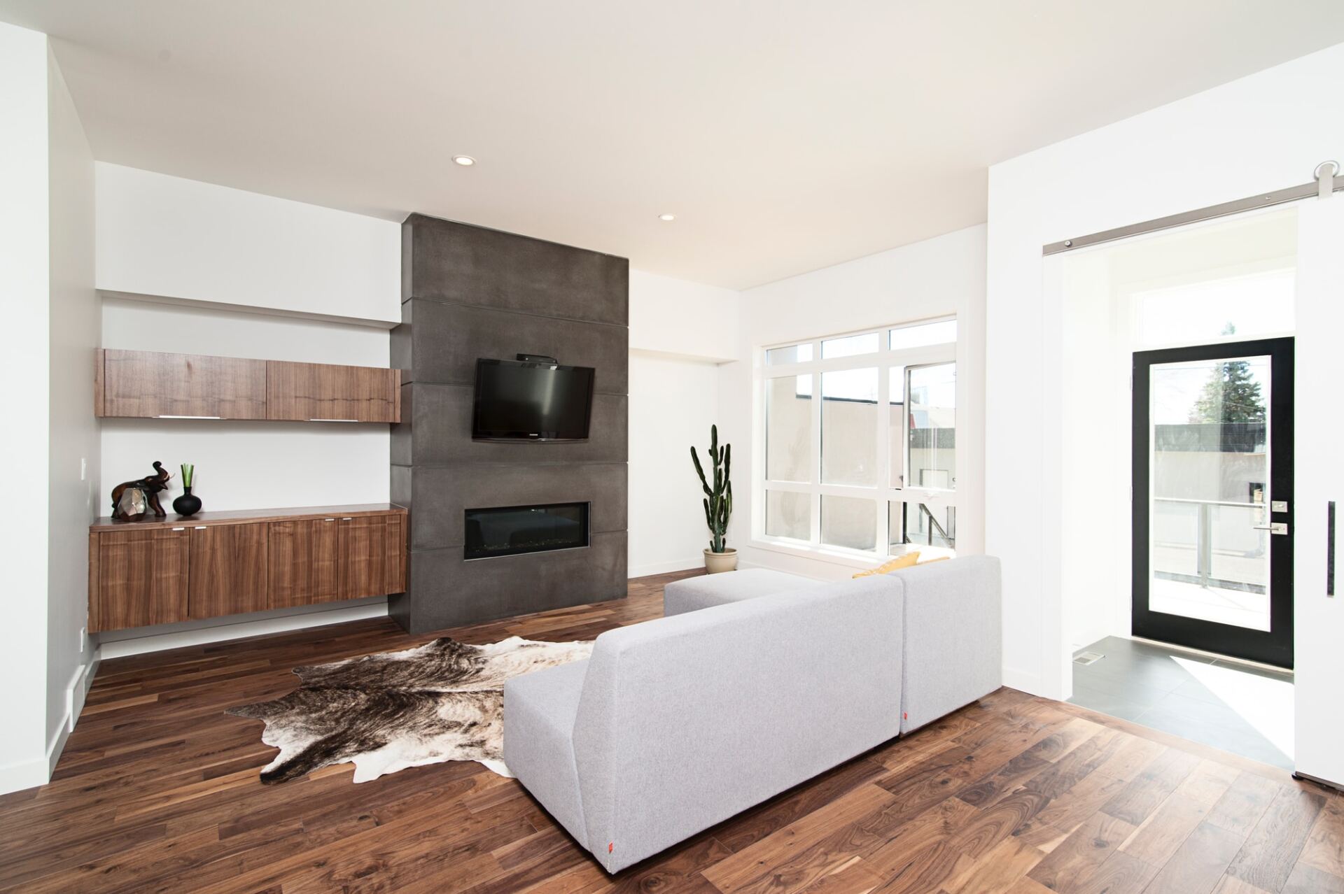 Ein Wohnzimmer mit Couch, Kamin und Fernseher.