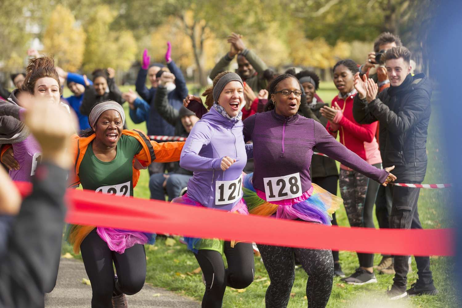 A group of people are running a race in a park.