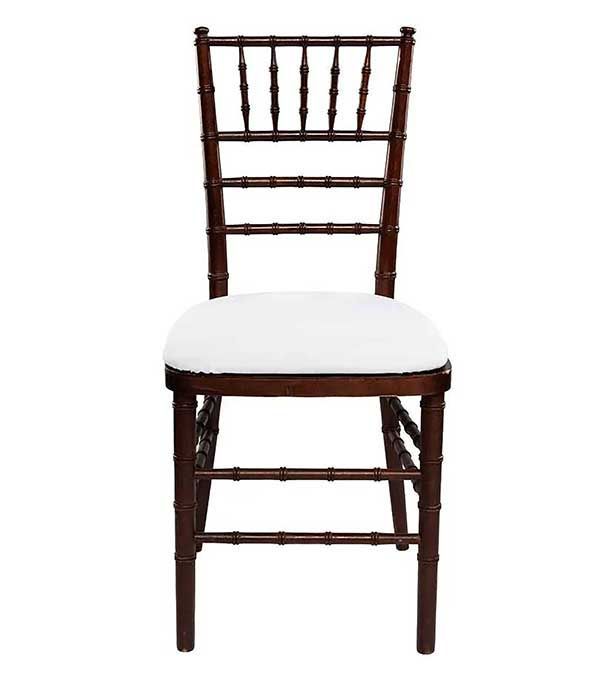 Dark wooden chair with a white cushioned seat on a plain background
