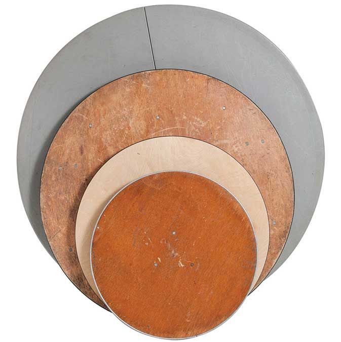 Overlapping semicircular wooden disks in gray, brown, cream, and orange, arranged in a layered circle.