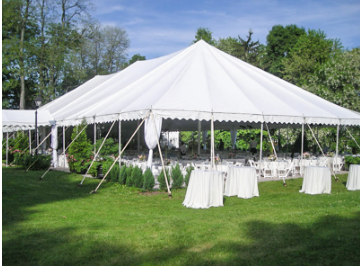 Inside a white event tent, strings of warm lights hang from the ceiling over empty tables.
