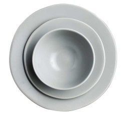 Stacked white plates and a bowl on a white background