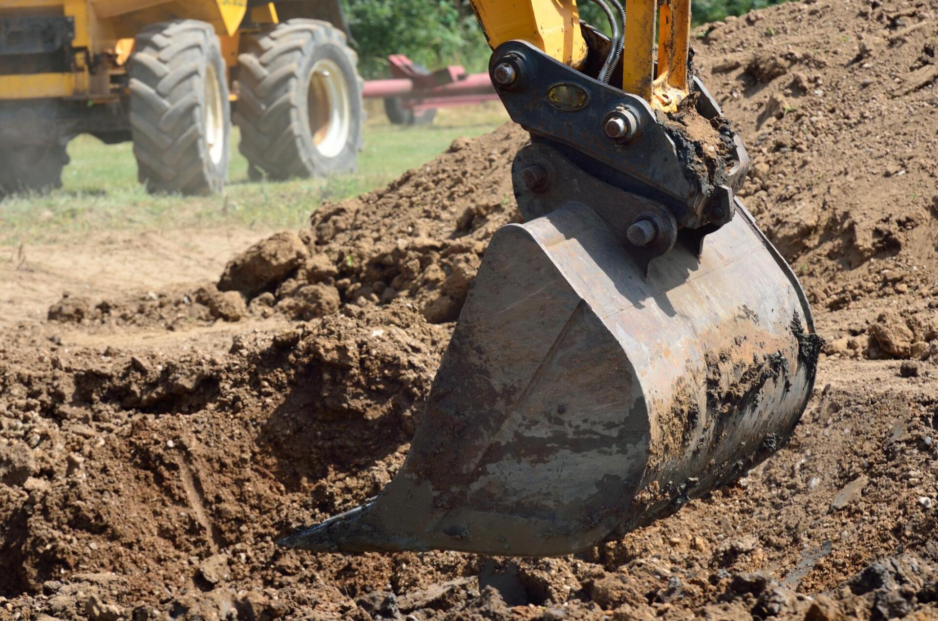 excavator removing below surface vegetation