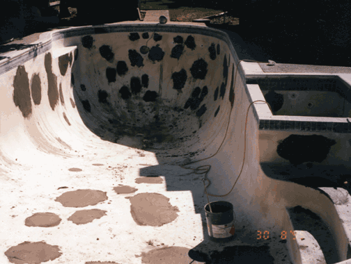 Swimming pool under construction; patches of concrete visible on the interior.
