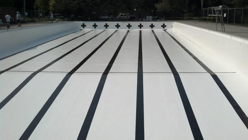 Empty, white swimming pool with black lane lines. Empty, white swimming pool with black lane lines.