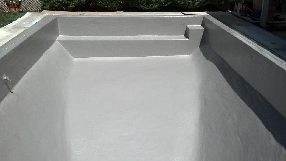 Empty, gray rectangular pool with built-in steps and coping. Empty, gray rectangular pool with built-in steps and coping.