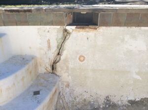 An overhead view of a white rectangular container with debris and shadows. An overhead view of a white rectangular container with debris and shadows.