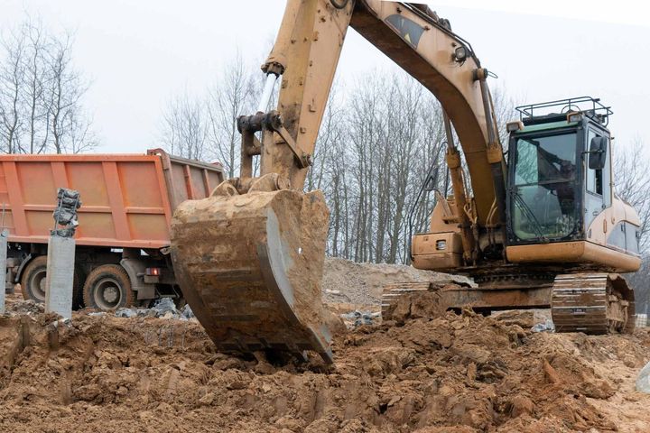 Photograph Of An Excavator Loads A Truck — Little Valley, NY — TRI R SERVICES