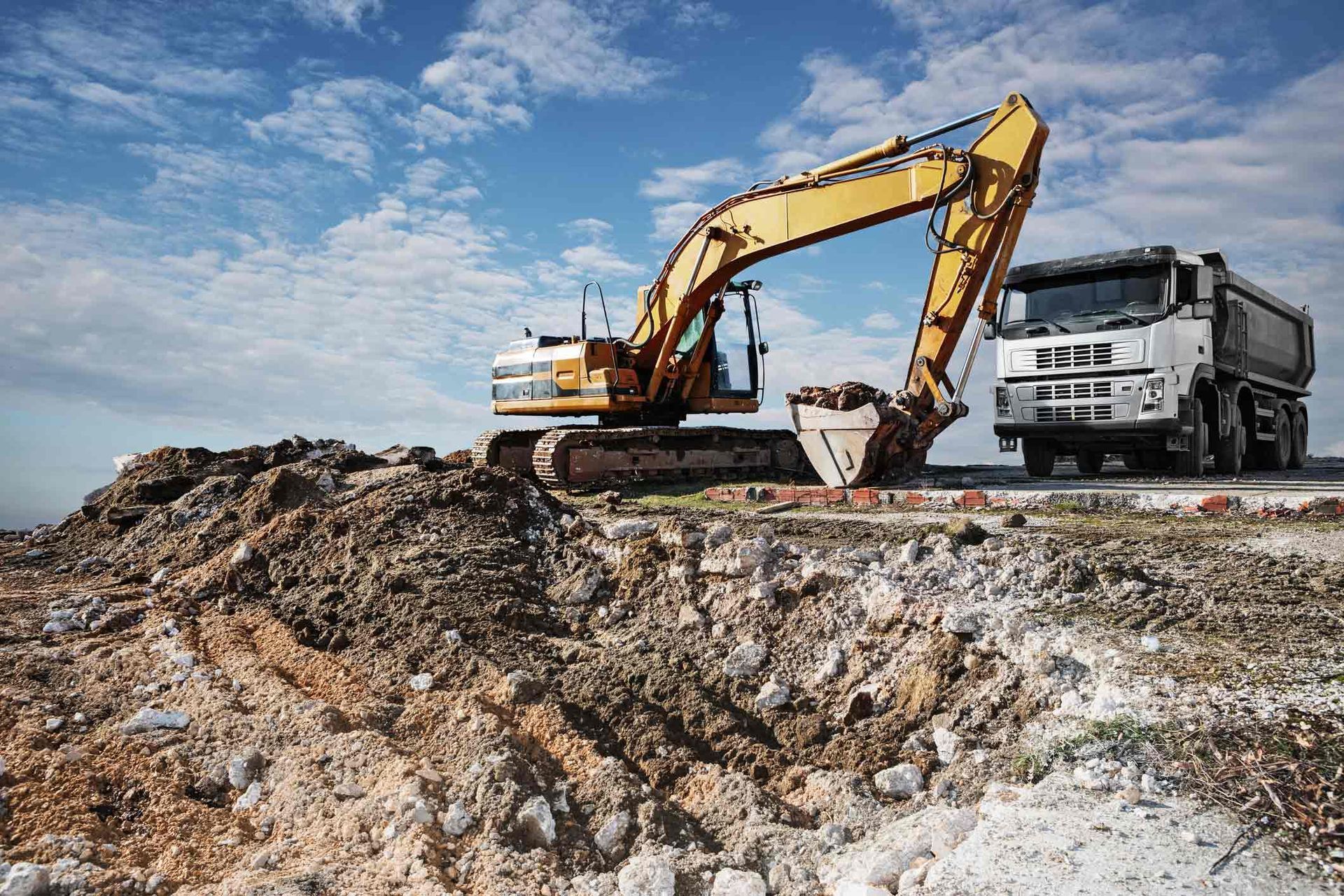 Excavator And Truck On A Construction Site — Little Valley, NY — TRI R SERVICES