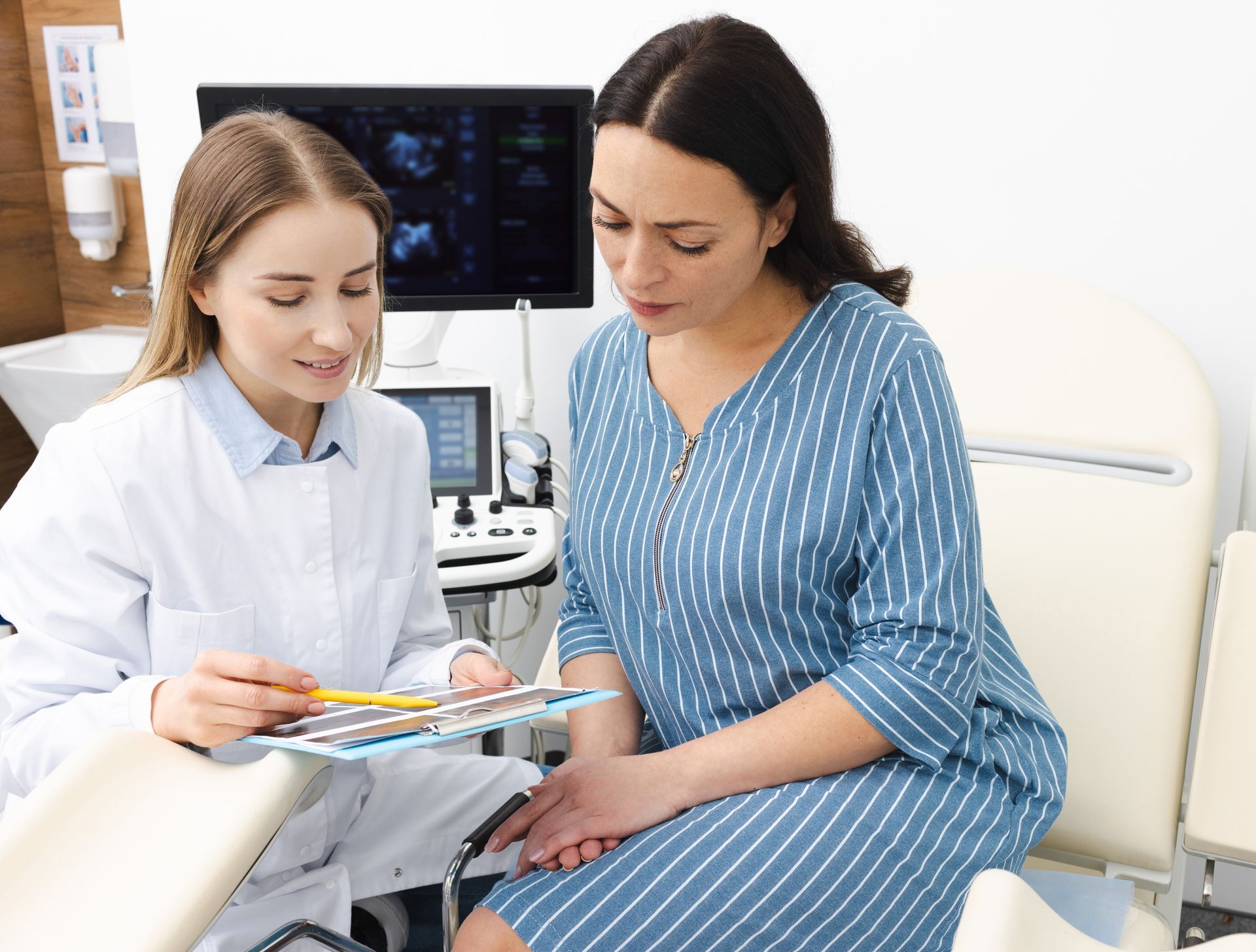 Doctor and woman patient are talking in a gynecological office during a visit at gynecology.